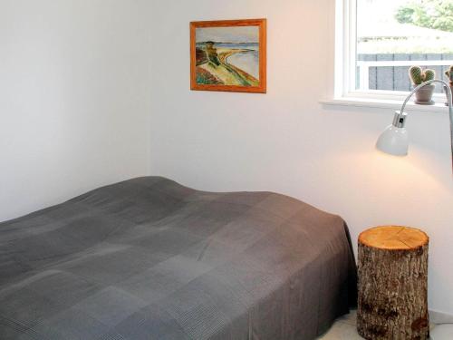 a bedroom with a bed and a table and a window at 8 person holiday home in Børkop in Børkop