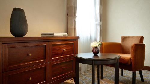 a living room with a dresser and a chair and a table at Lotte Arai Resort in Myoko
