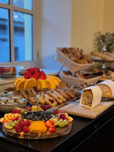 a table topped with lots of different types of food at Hotel De Boskar Peer in Peer