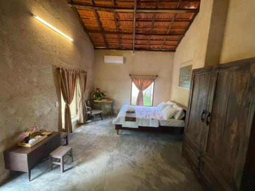 a bedroom with a bed and a window in a room at HappyZen Farm in Vung Tau
