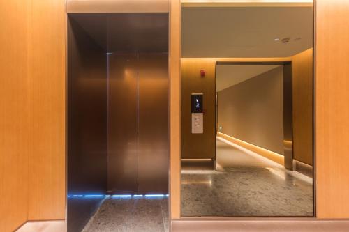 an elevator in a building with a mirror at JI Hotel Beijing Andingmen Andeli North Street in Beijing