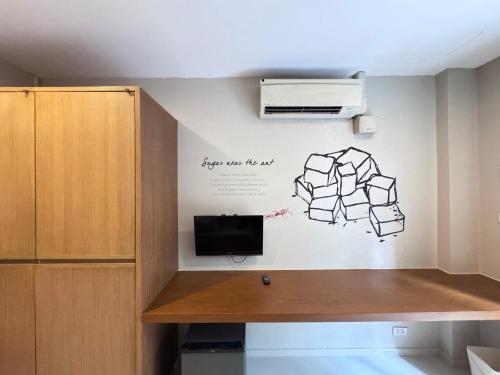 a room with a wall with a drawing on the wall at CHERN Bangkok in Bangkok
