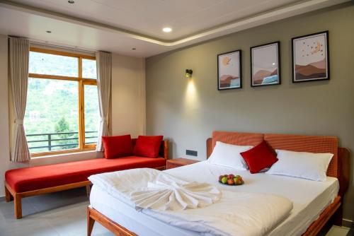 a bedroom with a bed and a chair and a window at sharan stay in Nagar