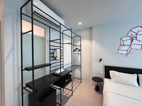 a room with a bed and a glass wall at CHERN Bangkok in Bangkok