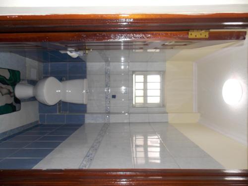 a view of a bathroom with a window and a tile floor at Axis guest house in Nairobi
