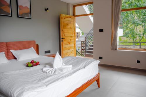 a bedroom with a bed with fruit on it at sharan stay in Nagar