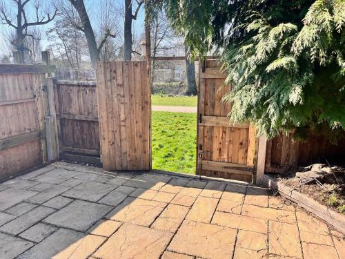 an entrance to a garden with a wooden gate at Eden Escape - Bham Airport, NEC, HS2, JLR, Park Access in Sheldon