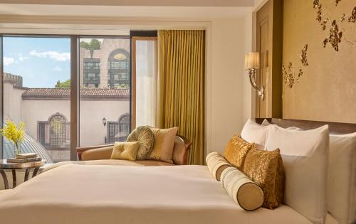 a hotel room with two beds and a large window at Mandarin Oriental, Taipei in Taipei