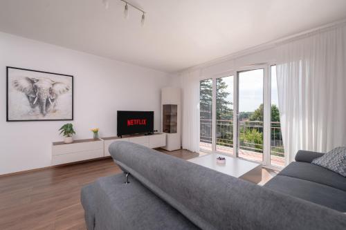 a living room with a couch and a tv at Apartment Rubina, 2 bedrooms, big terrace and secure parking in Medulin