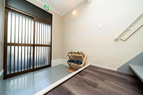 a room with a staircase and a large window at 三十三Inari in Kyoto
