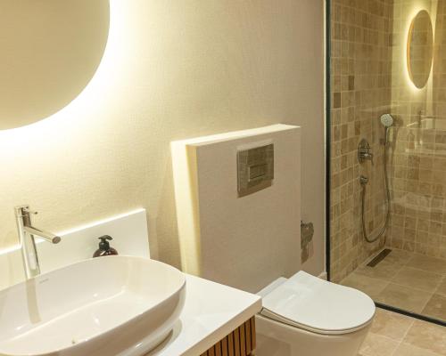een badkamer met een toilet, een wastafel en een douche bij Edra House in Alacati