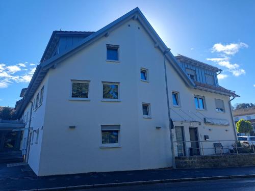 a white building with a black roof at Hotel Gasthof Schützen GbR in Laupheim
