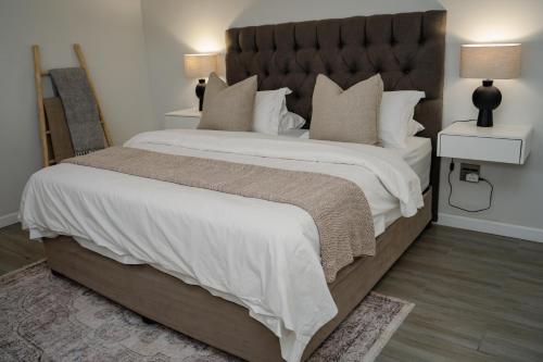 a bedroom with a large bed with a large headboard at Kénōsis Guestfarm- Two Bedroom Apartment in Springbok