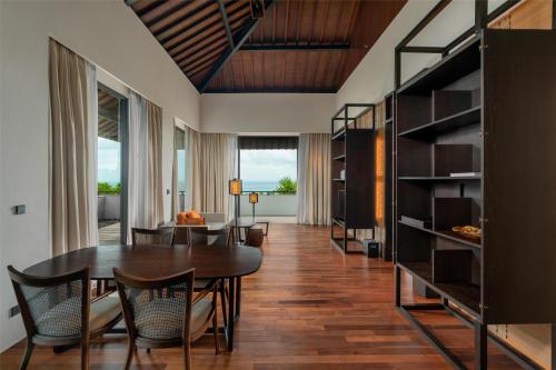 a dining room with a table and chairs at Radisson Blu Bali Uluwatu in Uluwatu