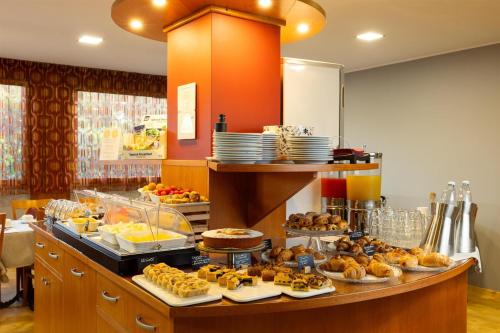 a buffet with many different types of pastries on display at La Villa - Sure Hotel Collection by Best Western in Ivrea