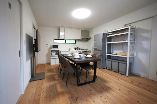 a kitchen and dining room with a table and chairs at The CATAN 久美浜 in Kyotango