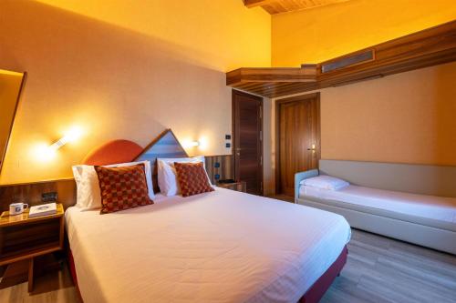 a hotel room with a large white bed with pillows at La Villa - Sure Hotel Collection by Best Western in Ivrea