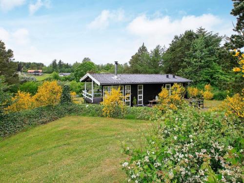 a small house in the middle of a yard at 4 person holiday home in Højslev in Højslev
