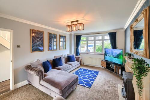 a living room with a couch and a tv at The Liverton in Billingham