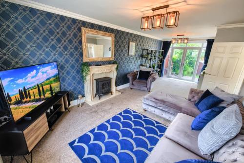 a living room with a couch and a tv at The Liverton in Billingham