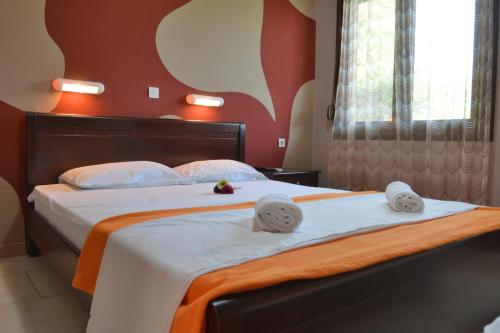 a bedroom with two beds with towels on them at Basilio's Studios in Leptokaria