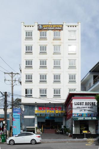 a white car parked in front of a building at Monaco Hotel Phú Quốc in Phu Quoc