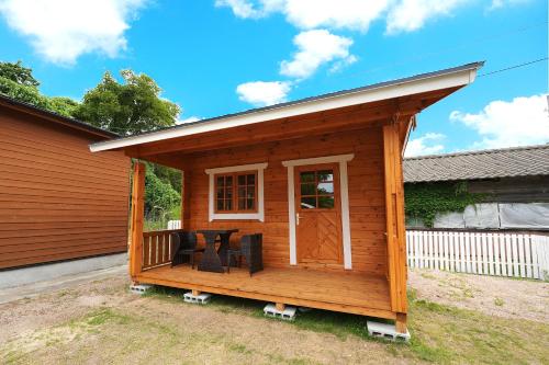 a large wooden cabin with a porch and a porch at The CATAN 久美浜 in Kyotango