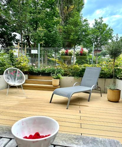 a patio with a chair and a bowl of water at Nice Sopot in Sopot
