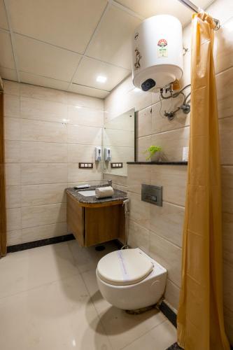 a bathroom with a toilet and a sink at Hotel Lotus Paradise in Rāi