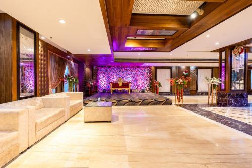 a living room with a couch and a table at Hotel Lotus Paradise in Rāi