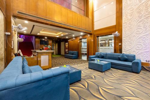 a living room with blue couches and a counter at Hotel Lotus Paradise in Rāi