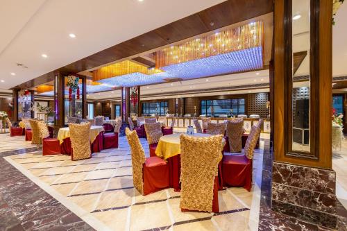 a restaurant with yellow tables and red chairs at Hotel Lotus Paradise in Rāi