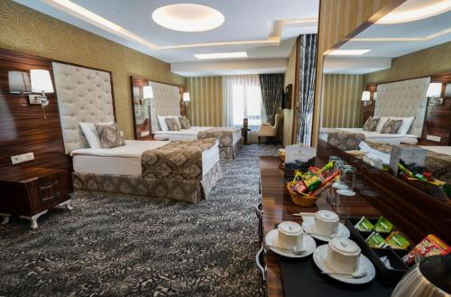 a hotel room with two beds and a living room at Ayder Hasimoglu Hotel in Ayder Yaylasi