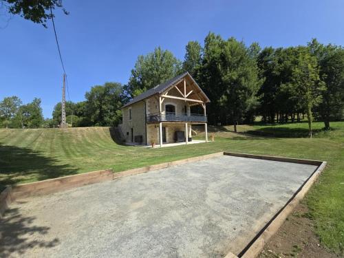 a house with a basketball court in the middle of a field at La maison d'elena in Thiviers