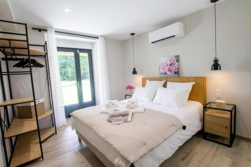 a bedroom with a large bed with a ladder at La maison d'elena in Thiviers