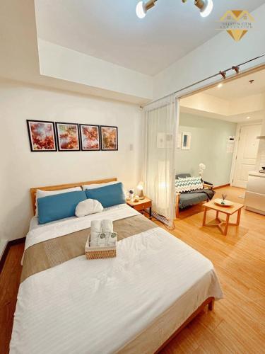 a large bedroom with a large bed and a living room at Havenscape Staycation in Manila