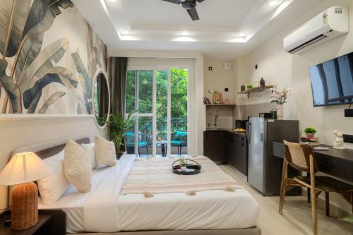 a bedroom with a large bed and a desk at One Stayz by Zipcode in Gurgaon