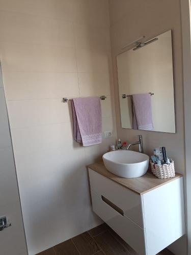 a bathroom with a sink and a mirror at Stella Marina in Bova Marina