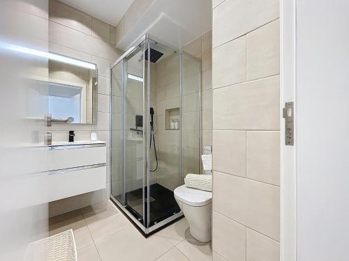 a bathroom with a toilet and a glass shower at Breeze House 2 by Atlantic Holiday in Garajau