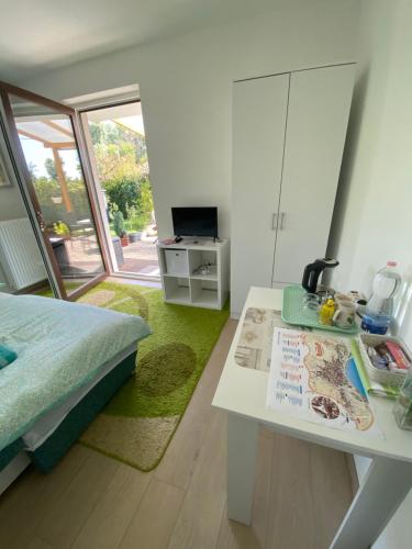Un dormitorio con una cama, un escritorio y una mesa. en Korzó Terasz Szentendre, en Szentendre