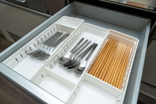 a drawer filled with utensils in a container at 三十三Inari in Kyoto