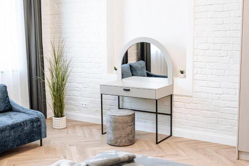a dressing table with a mirror in a living room at Vārves Muiža in Vārve