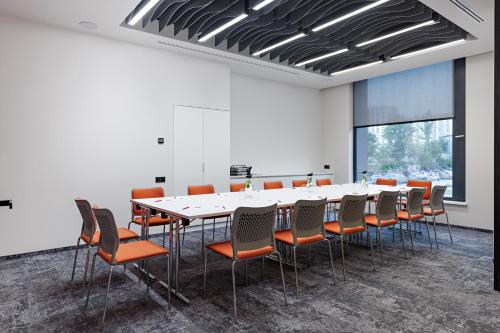 a conference room with a long table and chairs at TULIP Residences Lviv in Lviv