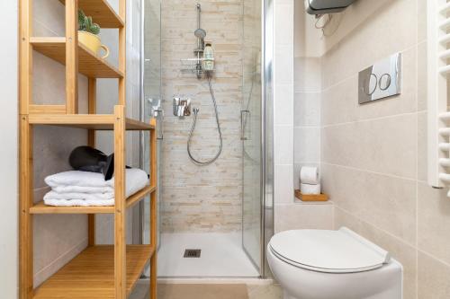 a small bathroom with a shower and a toilet at Cozy 1 BDR - Downtown Milan Navigli, Duomo in Milan