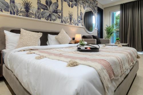 a bedroom with a large white bed and a couch at One Stayz by Zipcode in Gurgaon