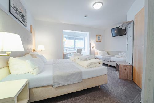 Postel nebo postele na pokoji v ubytování Sletz Parkhotel - Superior