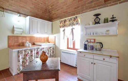 a kitchen with a table with a vase on it at Lovely Apartment In Civitella Benazzone in Civitella Benazzone