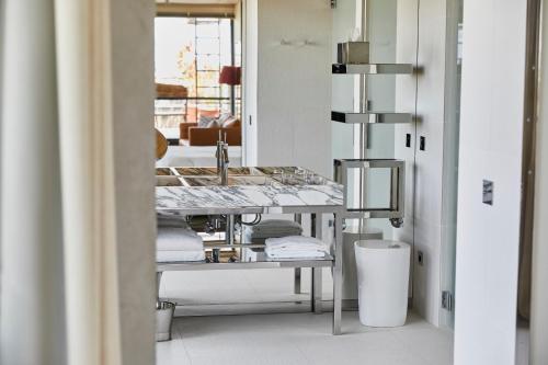 a bathroom with a sink and a counter with towels at Villa M in Paris