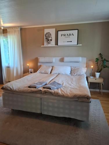 a bedroom with a large bed in a room at Riverside villa in Borlänge
