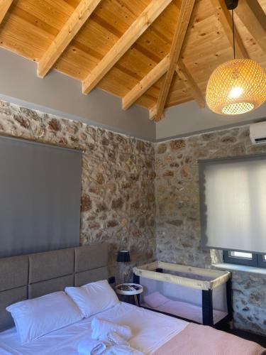 a bedroom with a bed and a projection screen at V&M Traditional Luxury Villa in Tolo